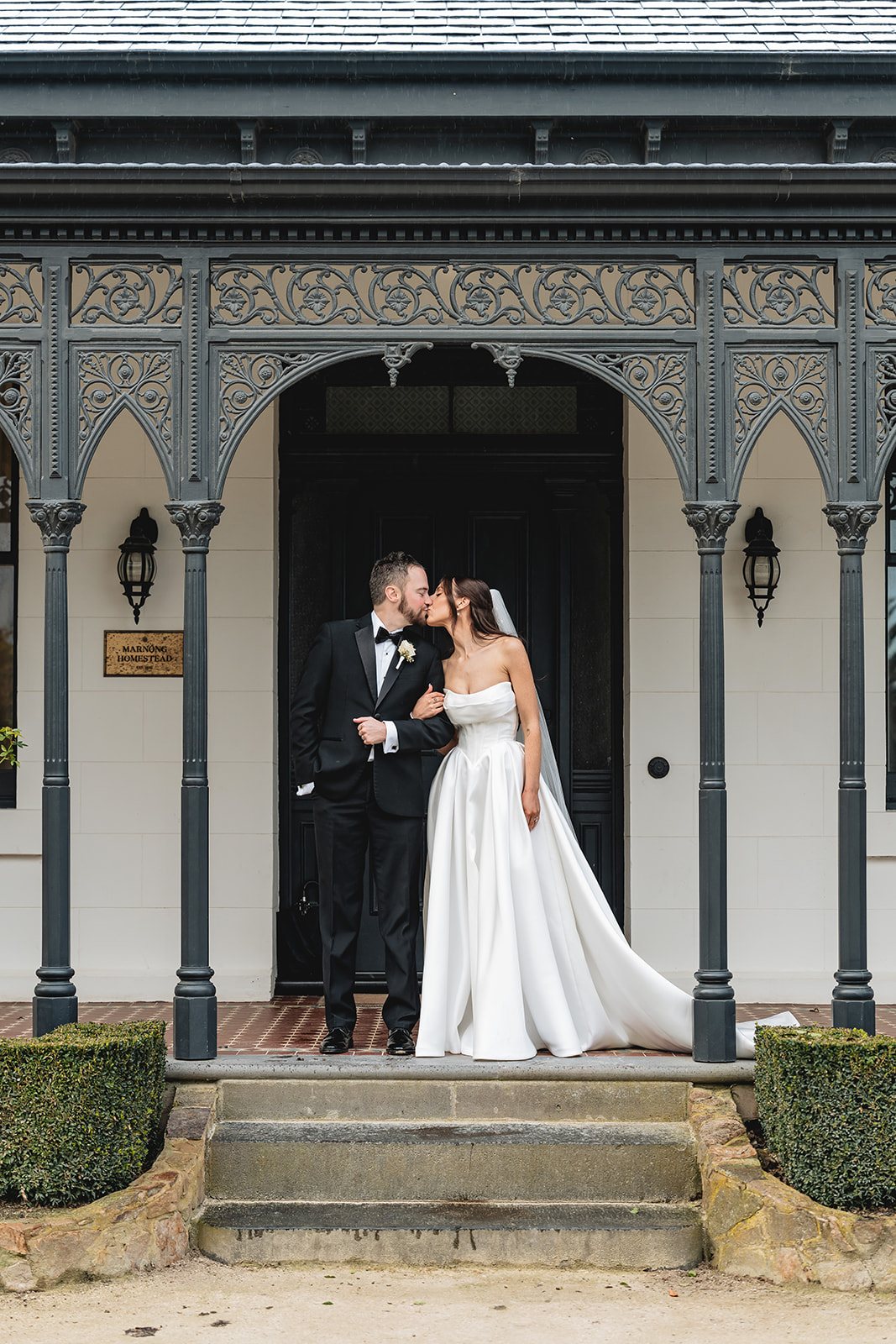 Marnong Estate wedding — bride and groom on the verandah of the 1842 homestead, by C2 Films