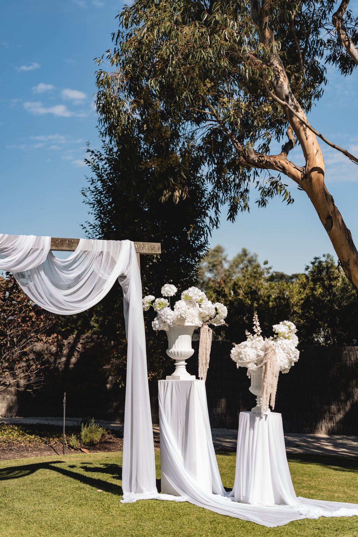 Marnong Estate wedding — outdoor ceremony arch beneath a gum tree, Mickleham, by C2 Films