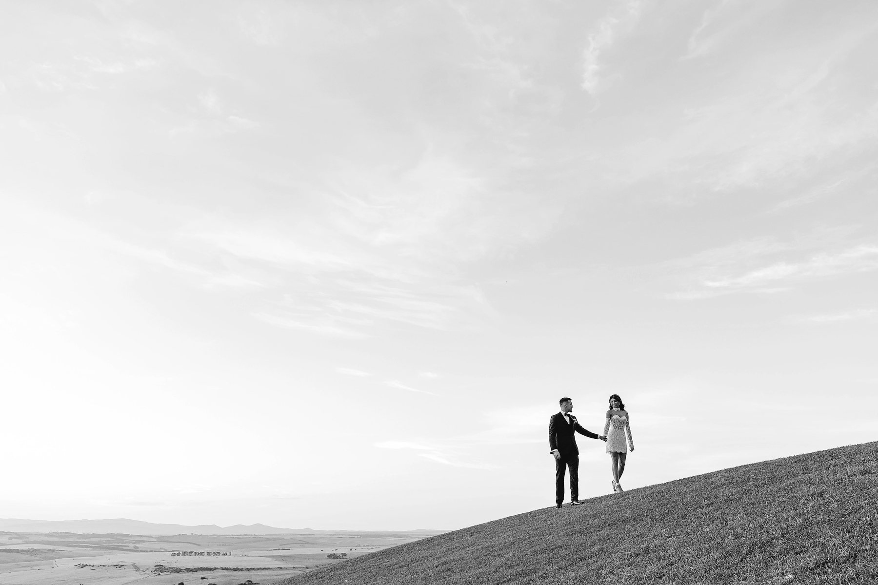 Marnong Estate wedding — couple on the open hillside beneath a vast sky, by C2 Films