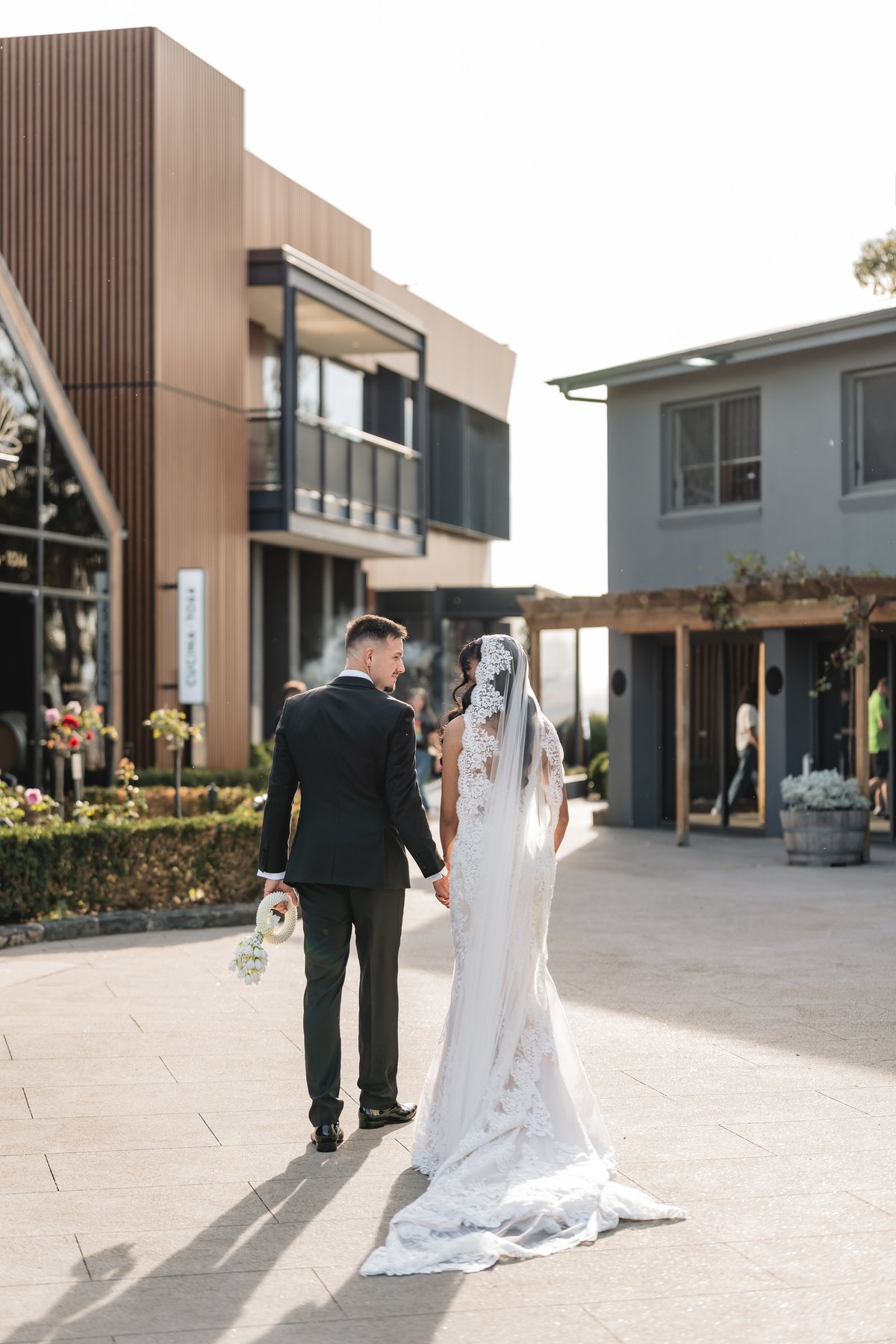 Marnong Estate wedding — walking towards the cellar door buildings, by C2 Films