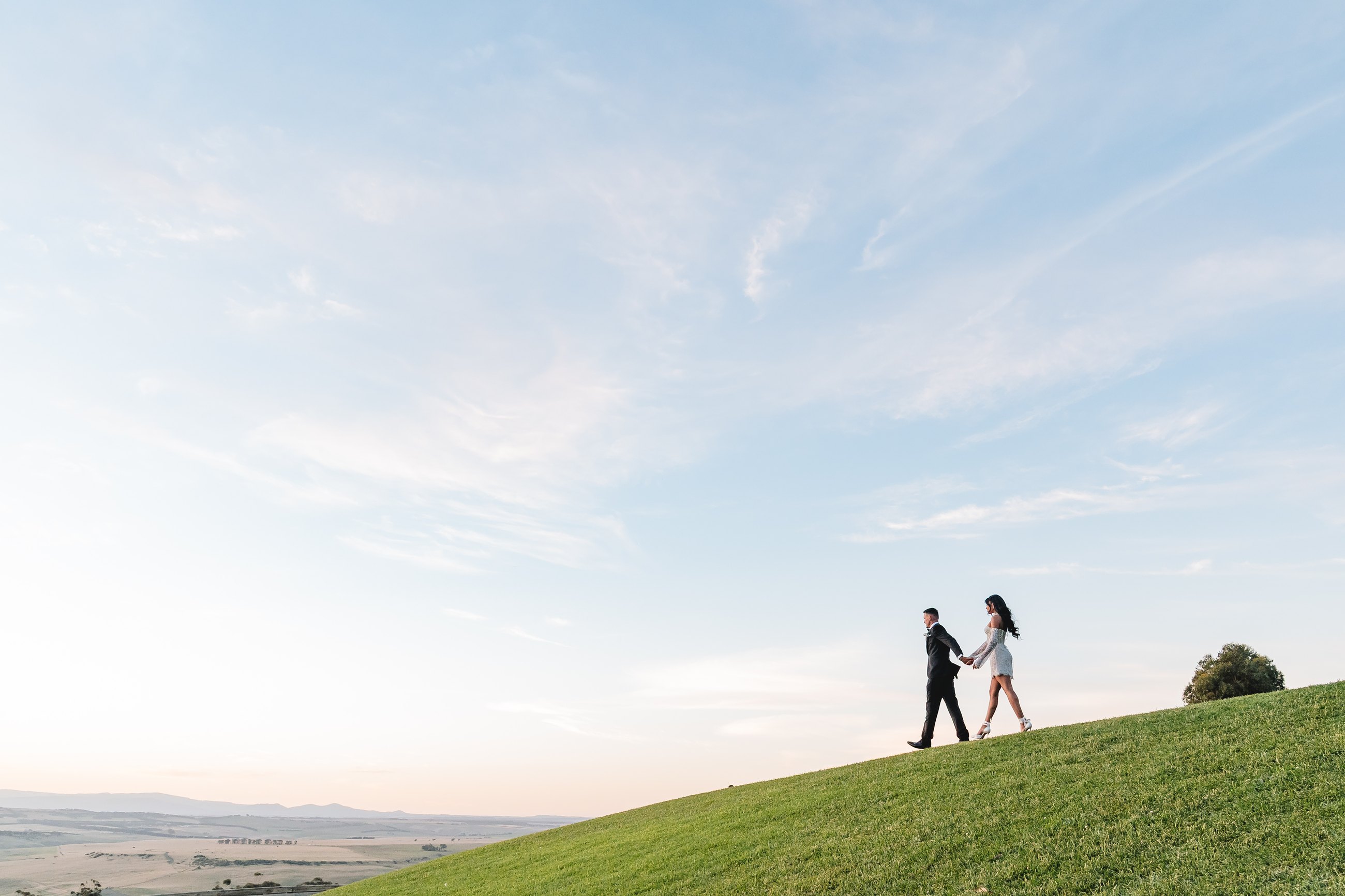 Marnong Estate wedding — bride and groom on the hill at dusk with the valley beyond, Mickleham, photographed by C2 Films