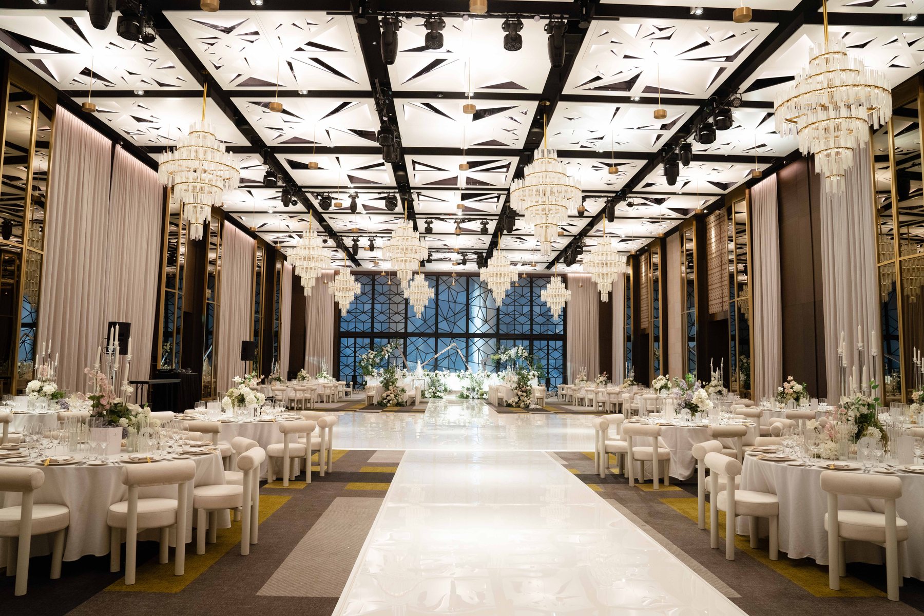 Ritz-Carlton Melbourne wedding — the Grand Ballroom set for a reception with chandeliers, by C2 Films