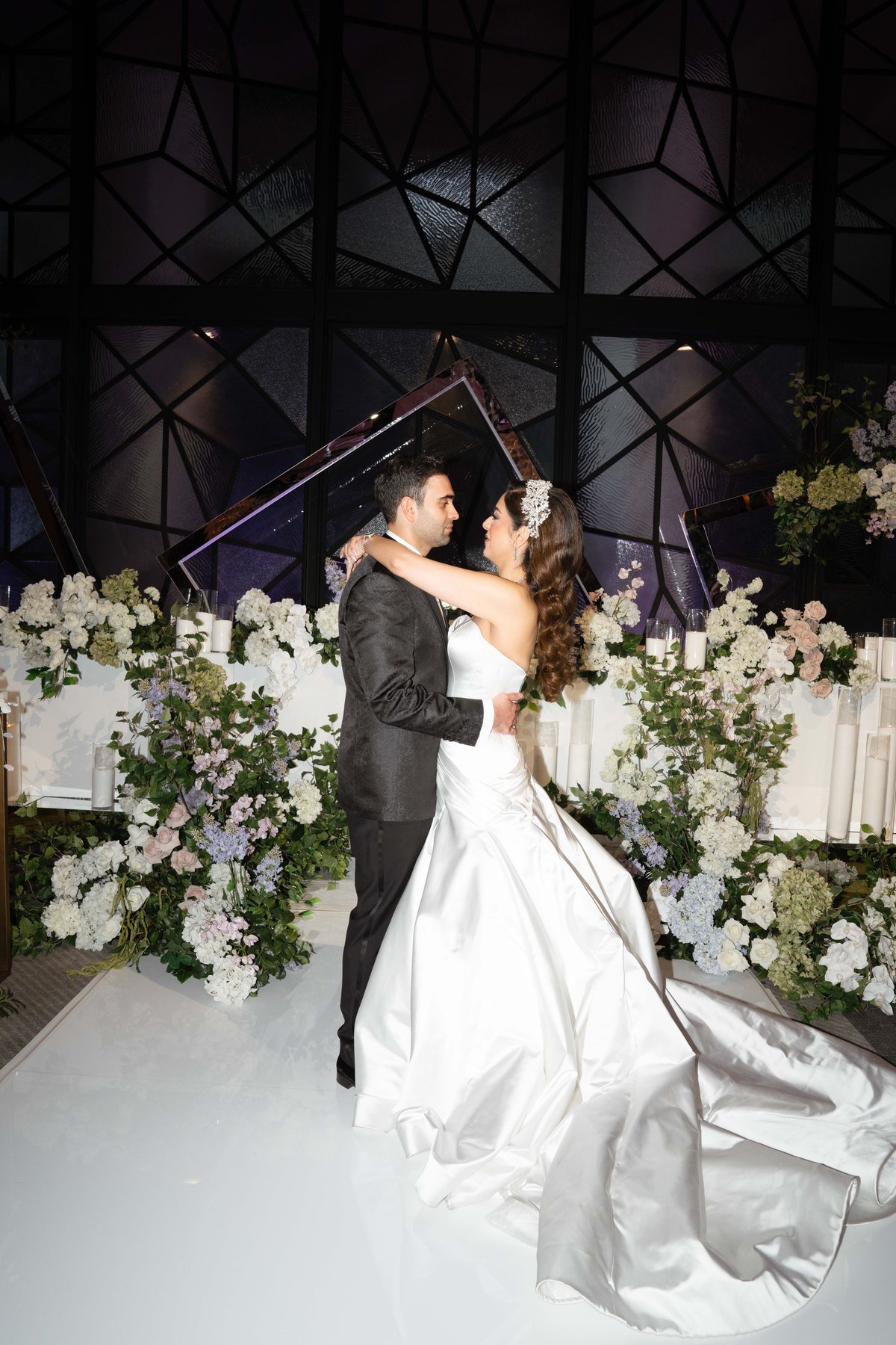 Ritz-Carlton Melbourne wedding — bride and groom against the geometric window wall, by C2 Films
