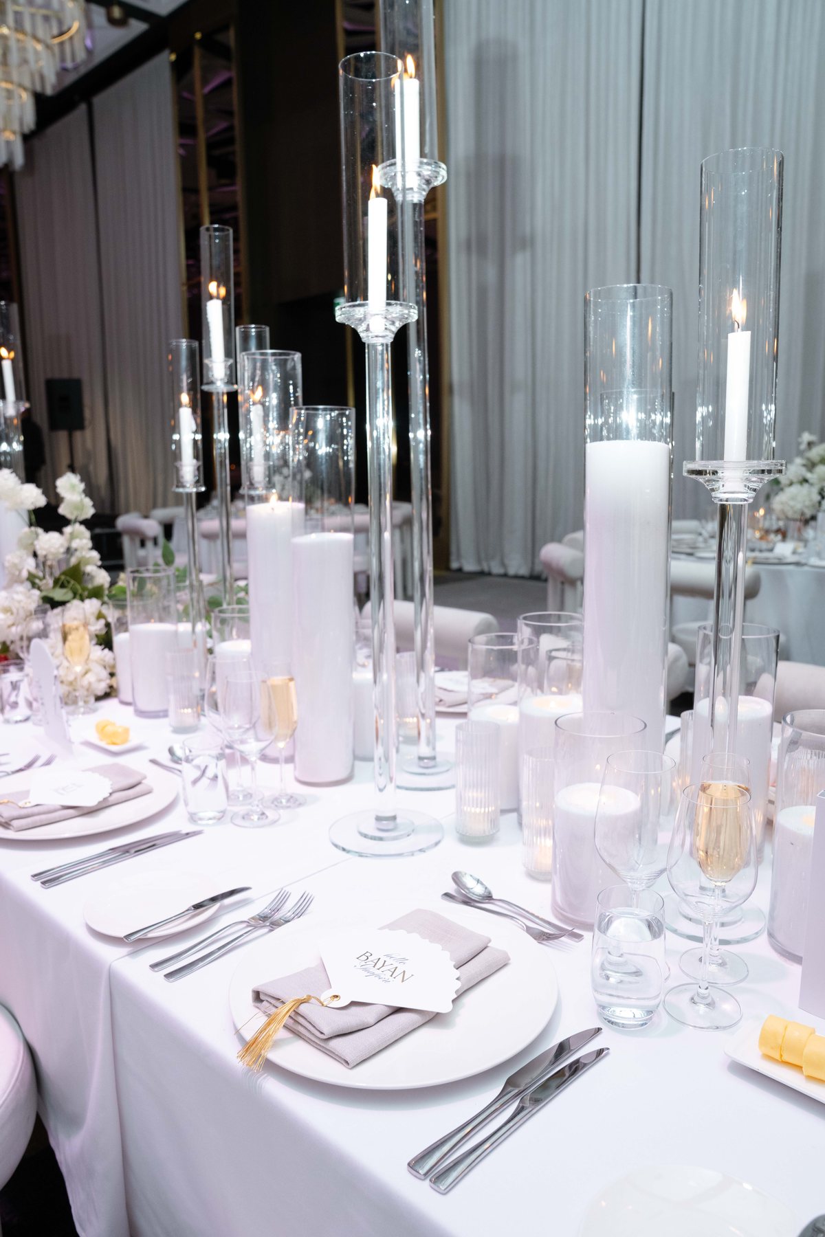 Ritz-Carlton Melbourne wedding — reception table with tall tapered candles, by C2 Films