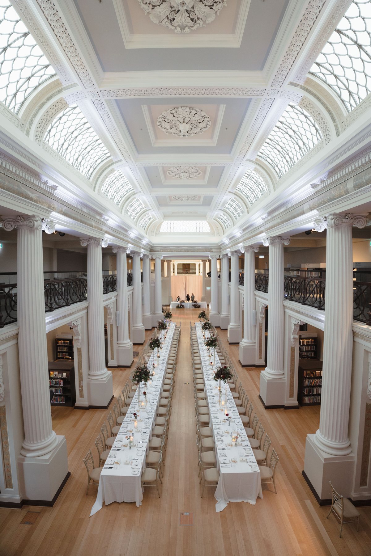 State Library Victoria wedding — long tables beneath the columns of Queen's Hall, by C2 Films