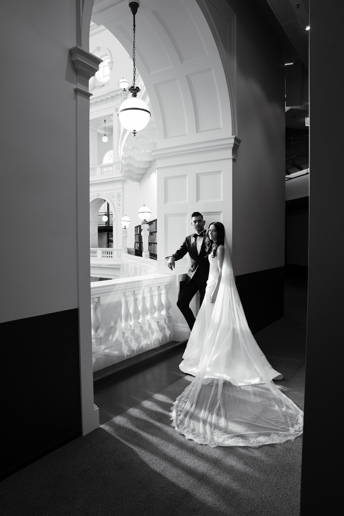 State Library Victoria wedding — bride in a heritage archway, black and white, by C2 Films