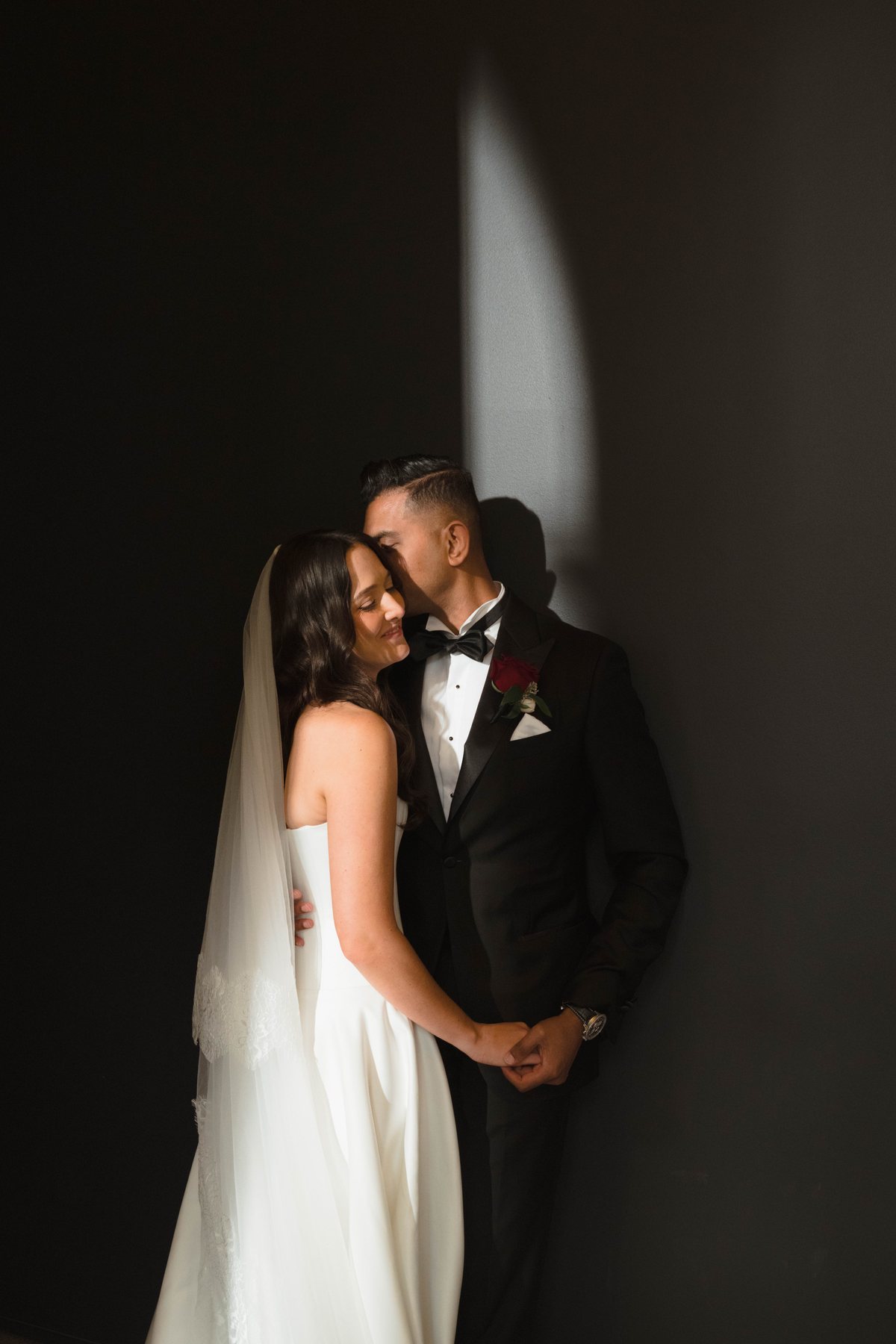 State Library Victoria wedding — couple in dramatic side light within the library, by C2 Films