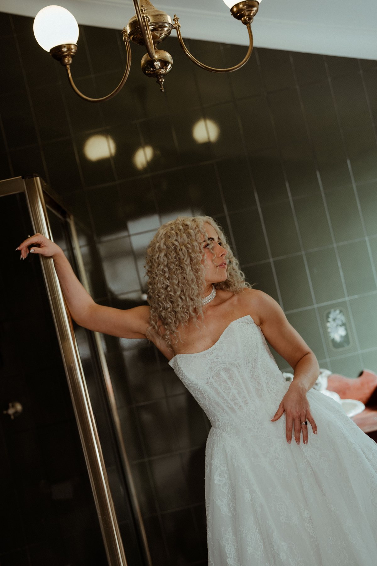 Monique posing against the panelled wall in her gown at Rosewood Estate, Beechmont QLD — wedding photography by C2 Films