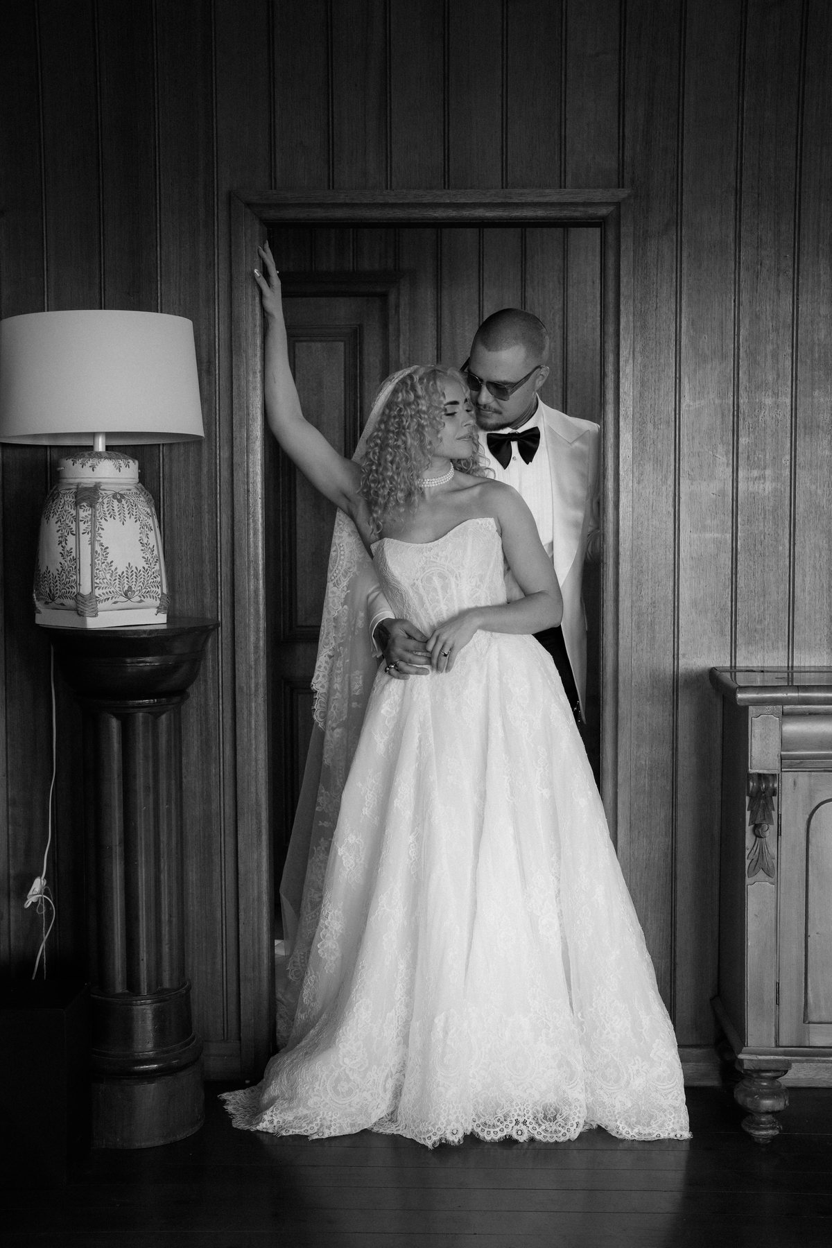Kaleb and Monique in black and white against the panelled wall at Rosewood Estate, Beechmont QLD — wedding photography by C2 Films