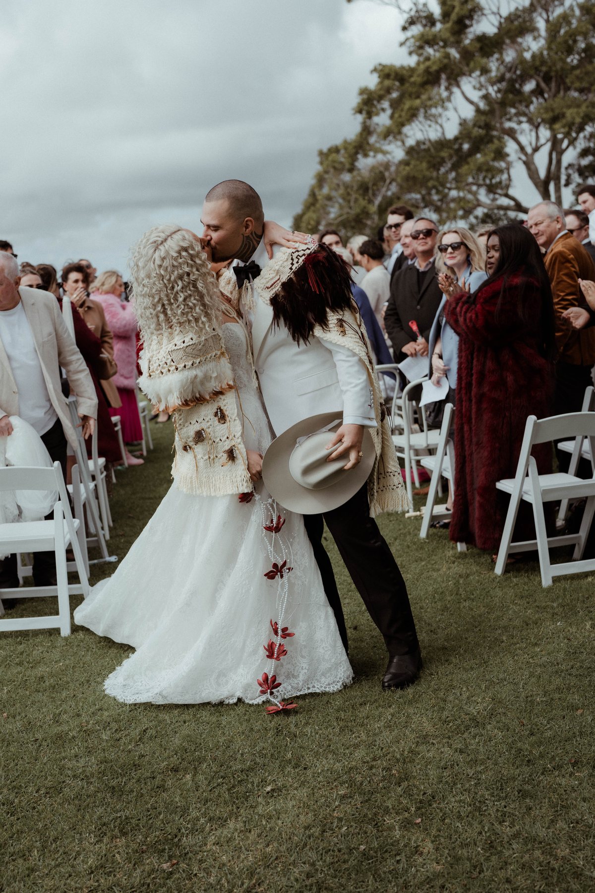 The recessional down the aisle in korowai at Rosewood Estate, Beechmont QLD — wedding photography by C2 Films
