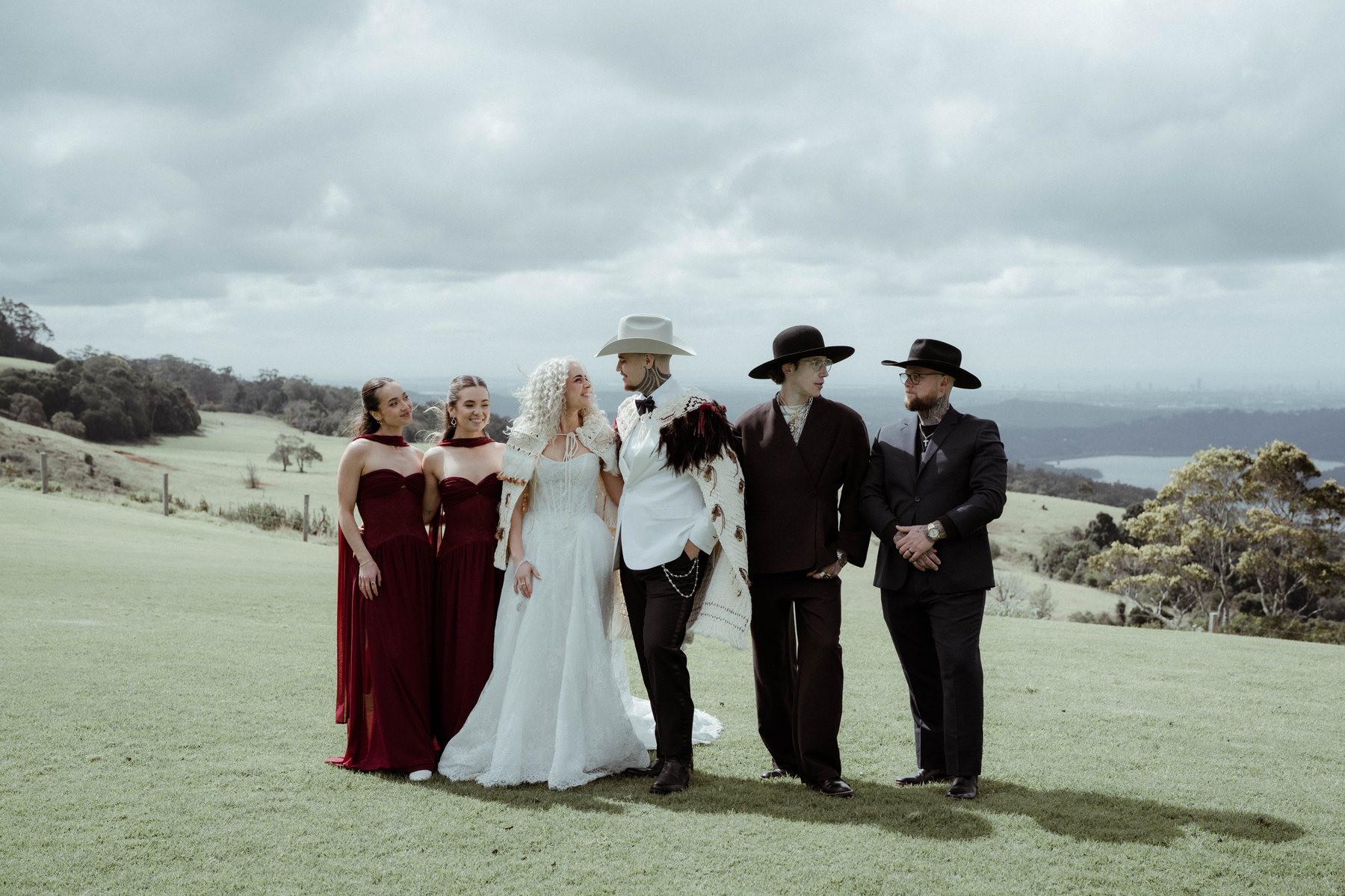 The bridal party on the hillside after the ceremony at Rosewood Estate, Beechmont QLD — wedding photography by C2 Films