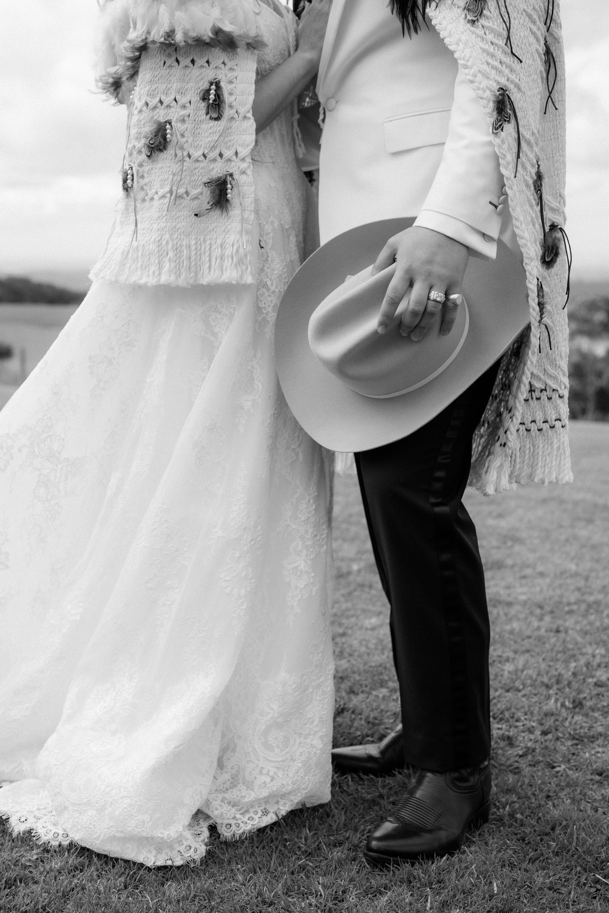 Detail of the korowai, gown and boots in black and white at Rosewood Estate, Beechmont QLD — wedding photography by C2 Films