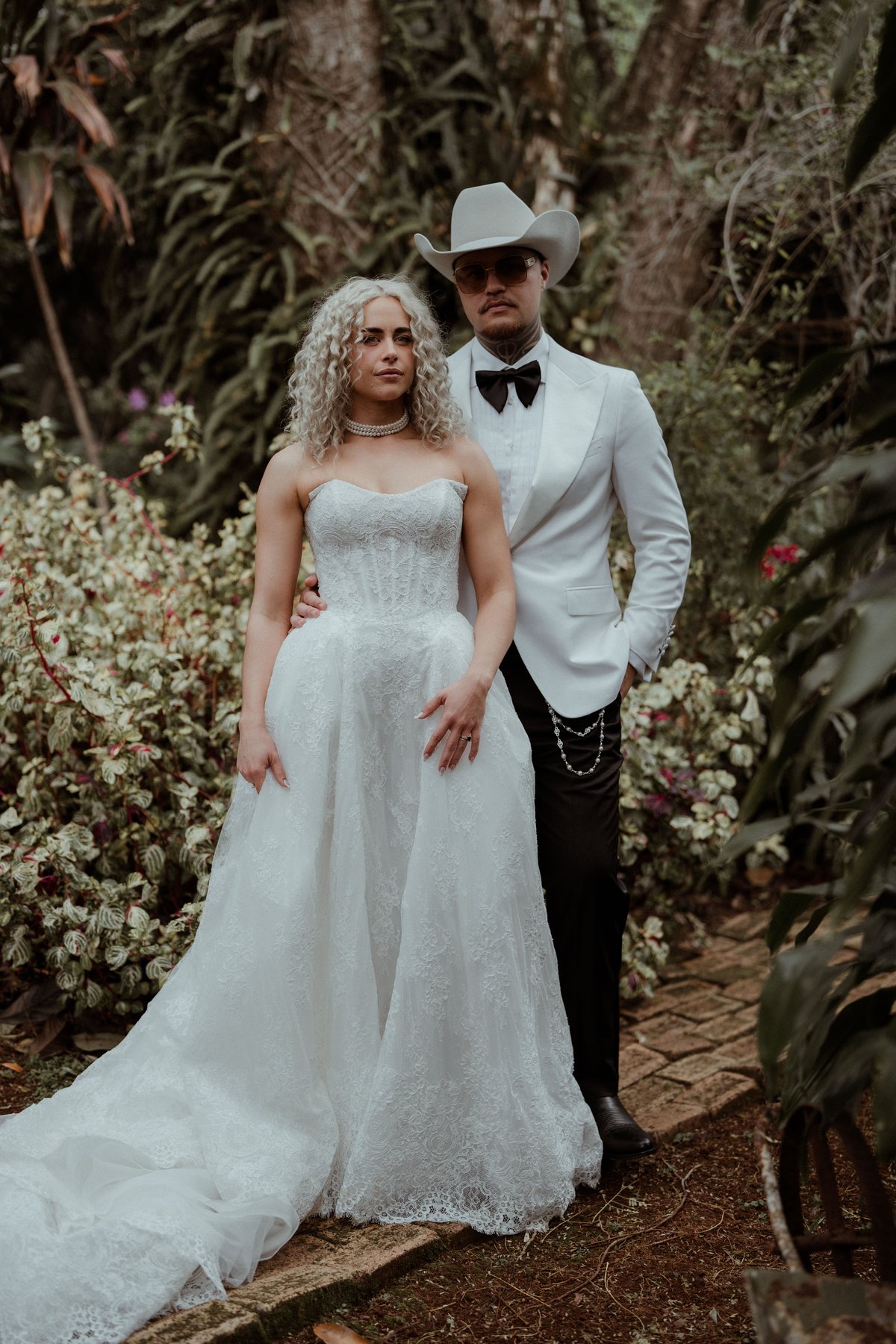 Kaleb and Monique in the garden after the ceremony at Rosewood Estate, Beechmont QLD — wedding photography by C2 Films