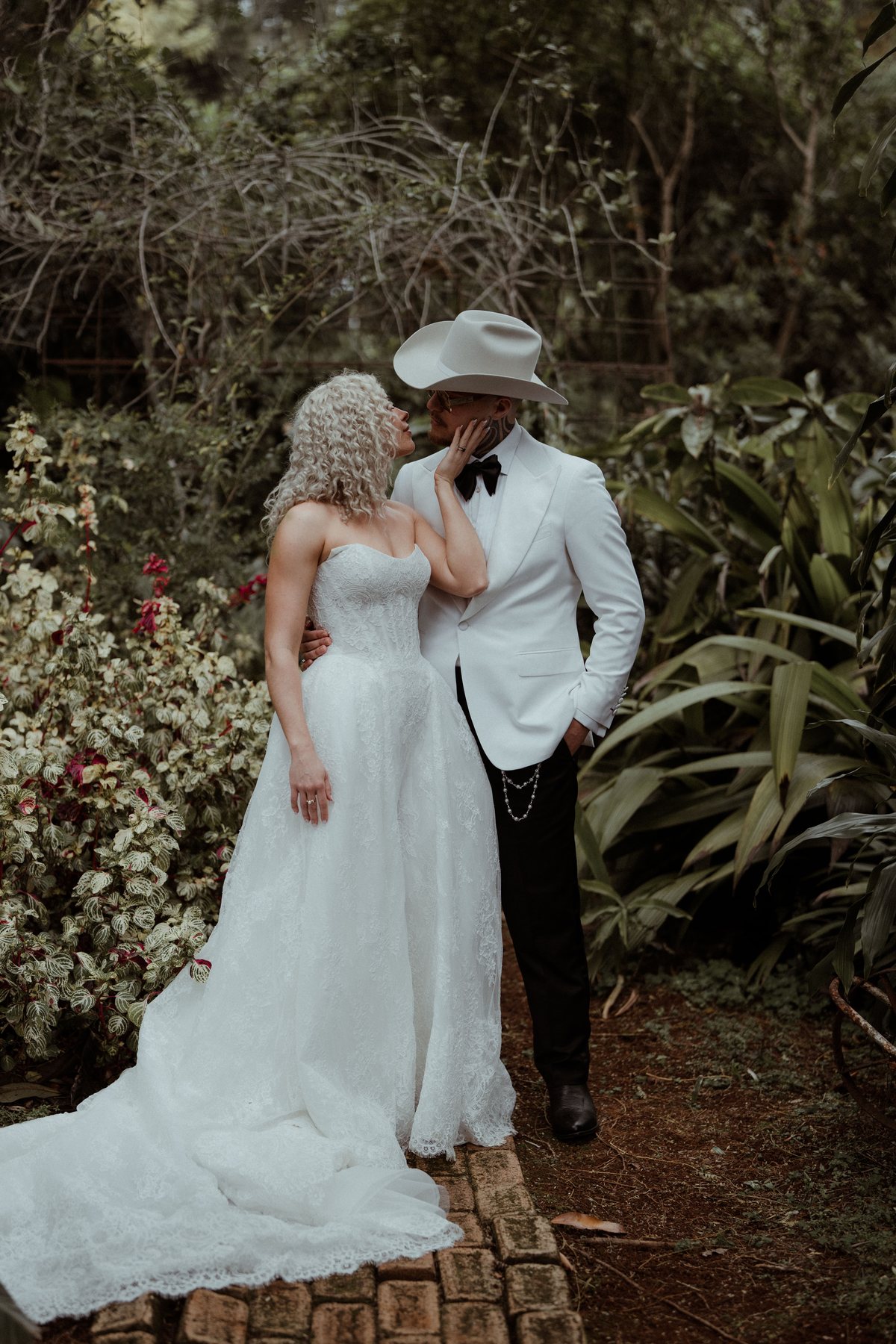 Kaleb and Monique in the greenery at dusk at Rosewood Estate, Beechmont QLD — wedding photography by C2 Films